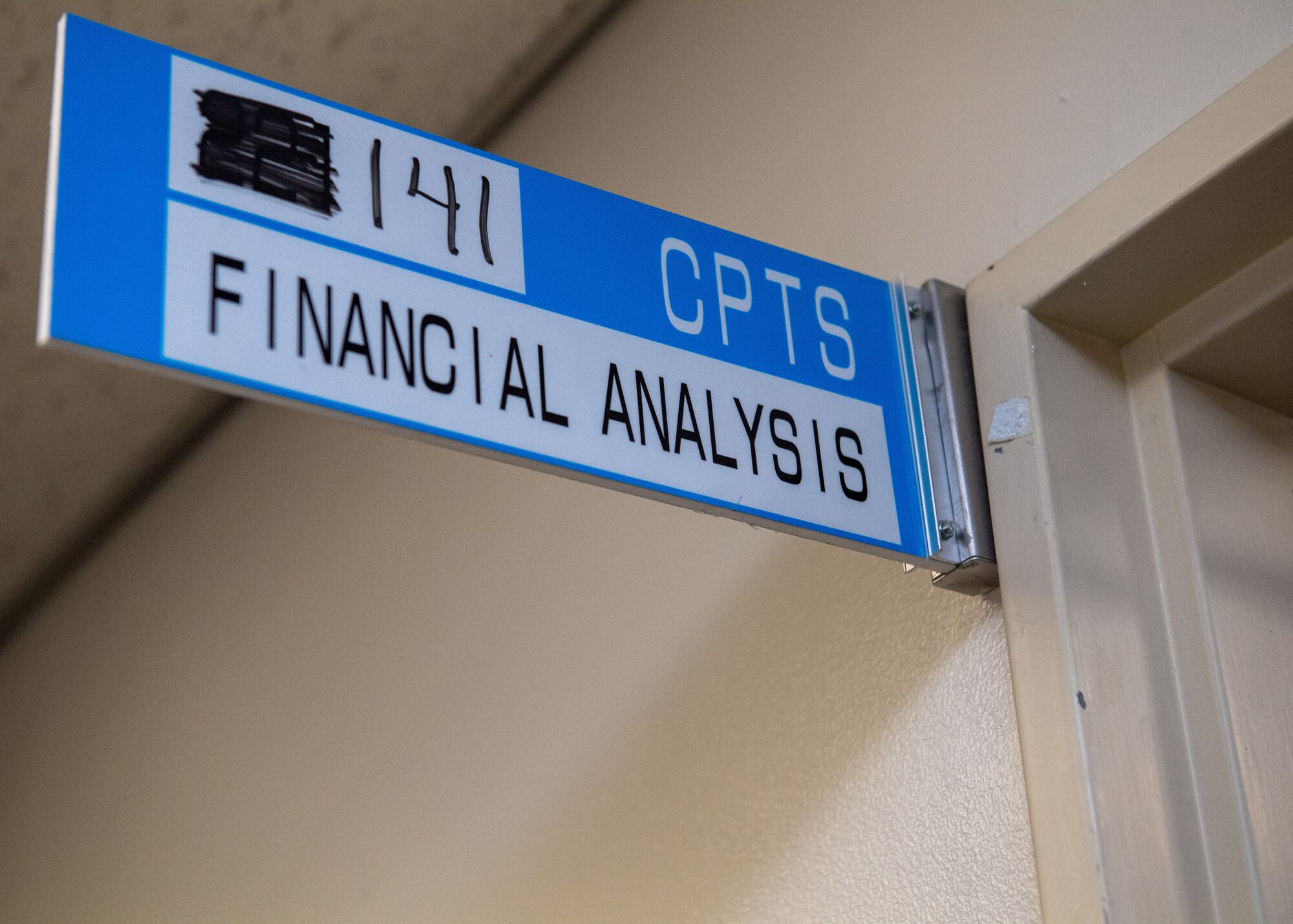 A sign is displayed above the entrance to the finance office on base.