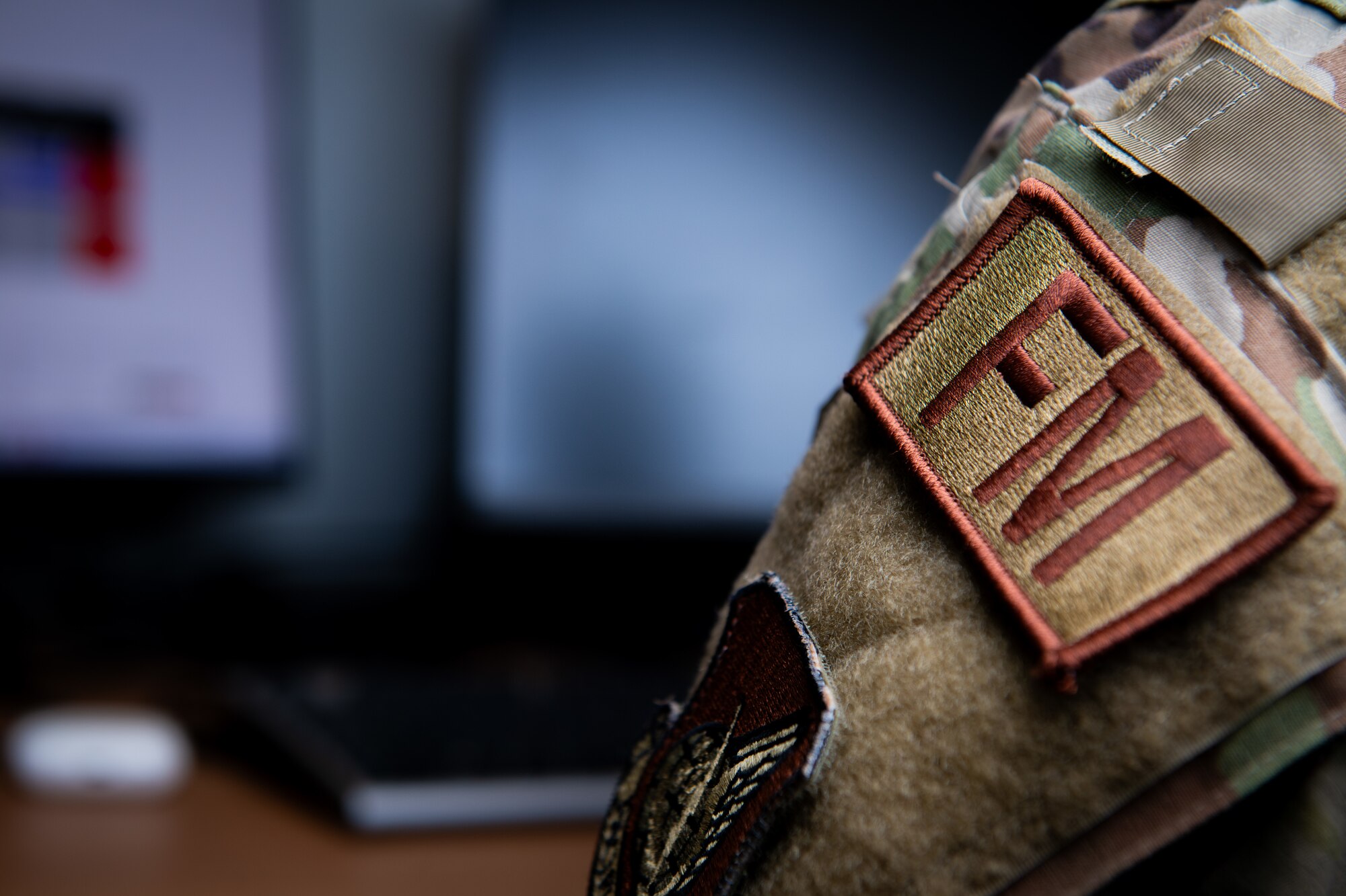 An Air Force job identifier uniform financial management patch is displayed on a uniform.