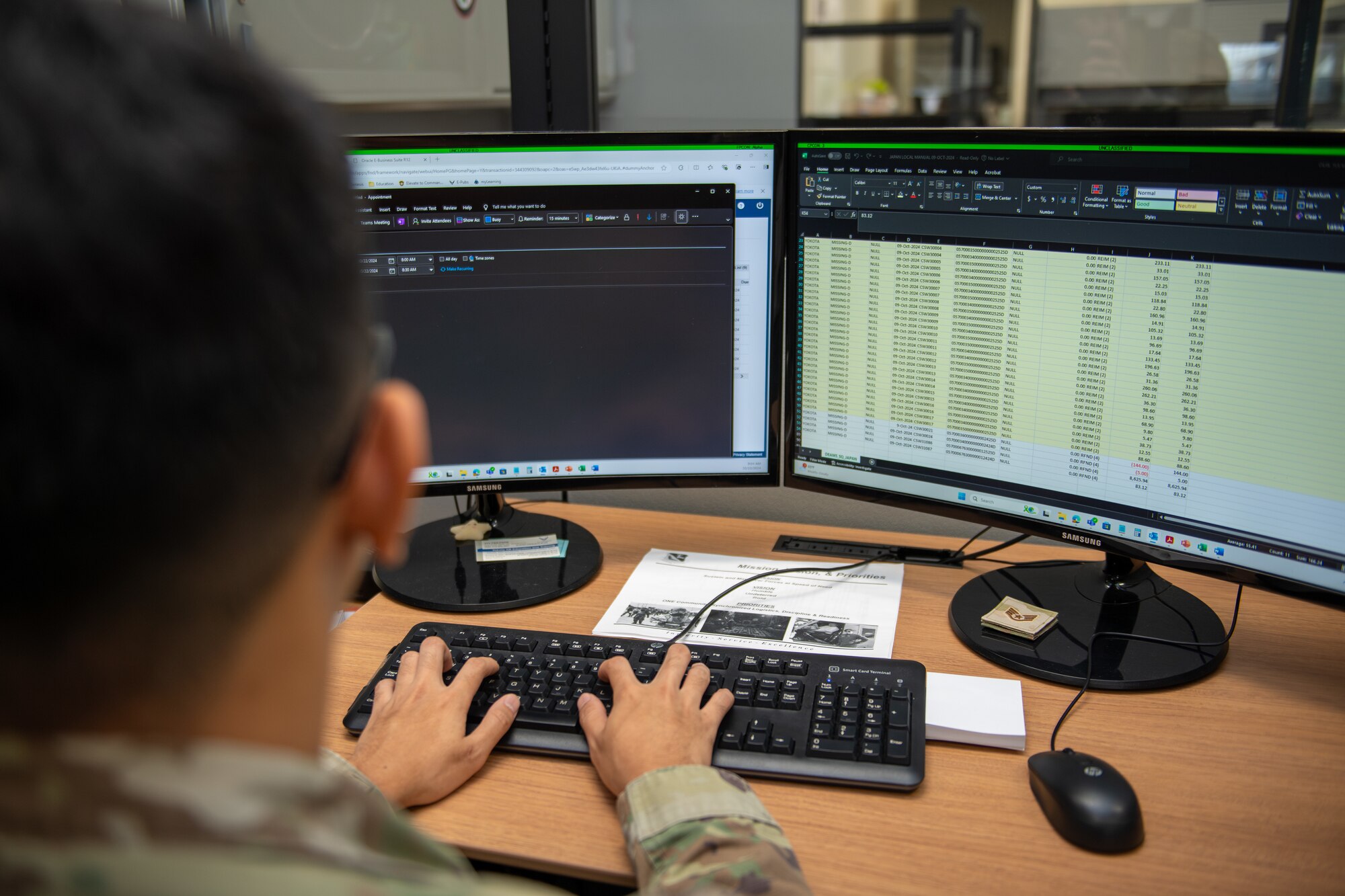 An airman looks at finances on a computer screen at the finance office.