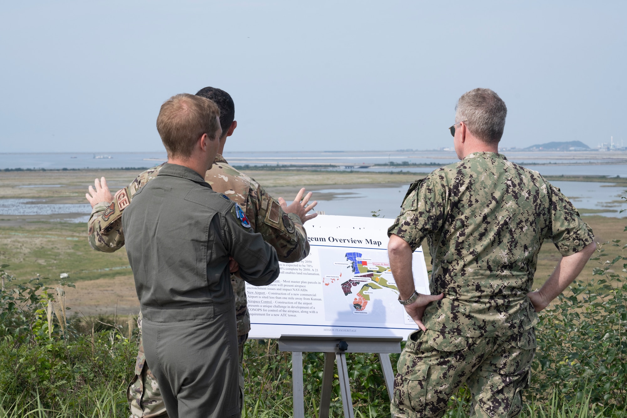 U.S. Air Force Lt. Col. Phil Compton, 8th Civil Engineer Squadron commander, briefs U.S. Navy Adm. Samuel J. Paparo, right, U.S. Indo-Pacific Command commander, on the Saemanguem construction project during a base visit.