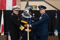 U.S. Navy Adm. Samuel Paparo, U.S. Indo-Pacific Command commander, presents the guidon to Lt. Gen. Stephen Jost, incoming U.S. Forces Japan and 5th Air Force commander, during a change of command ceremony at Yokota Air Base, Japan, Oct. 8, 2024. During the ceremony, command of USFJ and 5AF formally transferred from Lt. Gen. Ricky Rupp to Lt. Gen. Stephen Jost. (U.S. Air Force photo by Senior Airman Alexzandra Gracey)