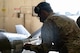 Senior Airman Christo Jose, 23rd Bomber Generation Squadron load team member, opens an access hatch on an inert GBU-31 in preparation to load it onto a B-52H Stratofortress at Minot Air Force Base, Oct. 4, 2024. Christo served on a team competing on how efficiently and safely they can load the munition onto the aircraft. (U.S. Air Force photo by Airman 1st Class Wesley Davies