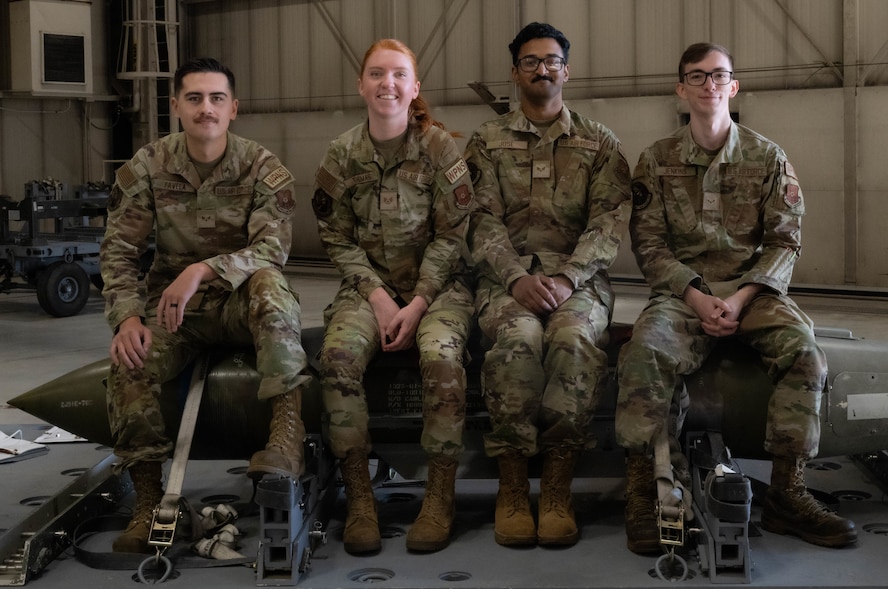 Airmen assigned to the 23rd Bomber Generation Squadron pose for a group photo before taking part in the third-quarter load competition at Minot Air Force Base, Oct. 4, 2024. The load competition is held quarterly and ensures Operational readiness. (U.S. Air Force photo by Airman 1st Class Wesley Davies)