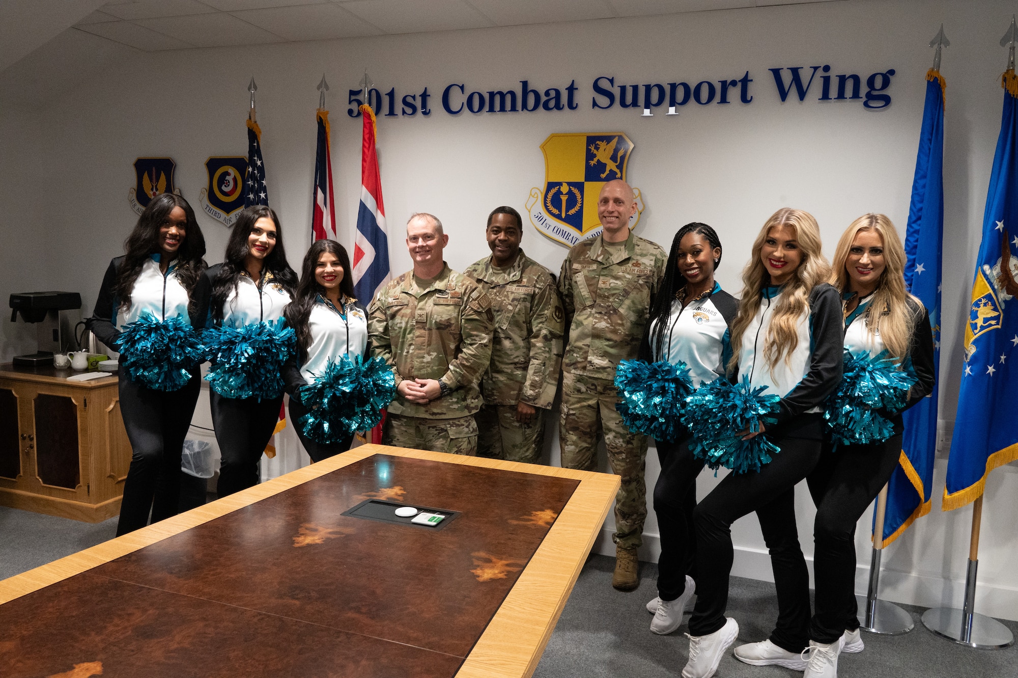 Members of the 501st Combat Support Wing leadership team pose with the Jacksonville Jaguars Roar Cheerleader Squad