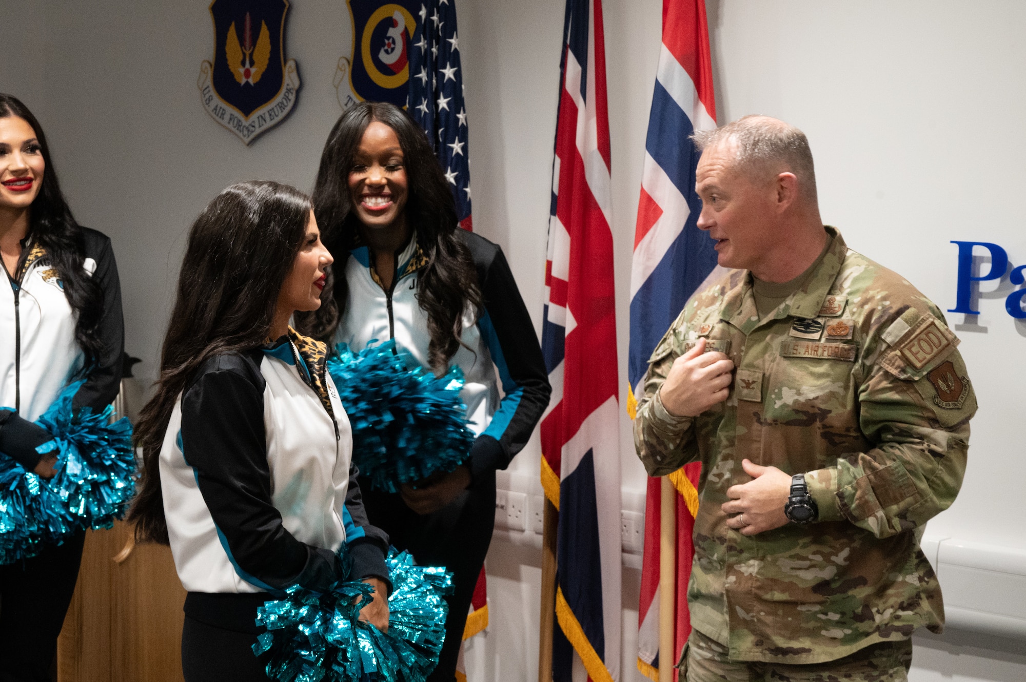 U.S. Air Force Col. D. Landon Phillips, 501st Combat Support Wing commander, talks with the Jacksonville Jaguars Roar Cheerleader Squad.