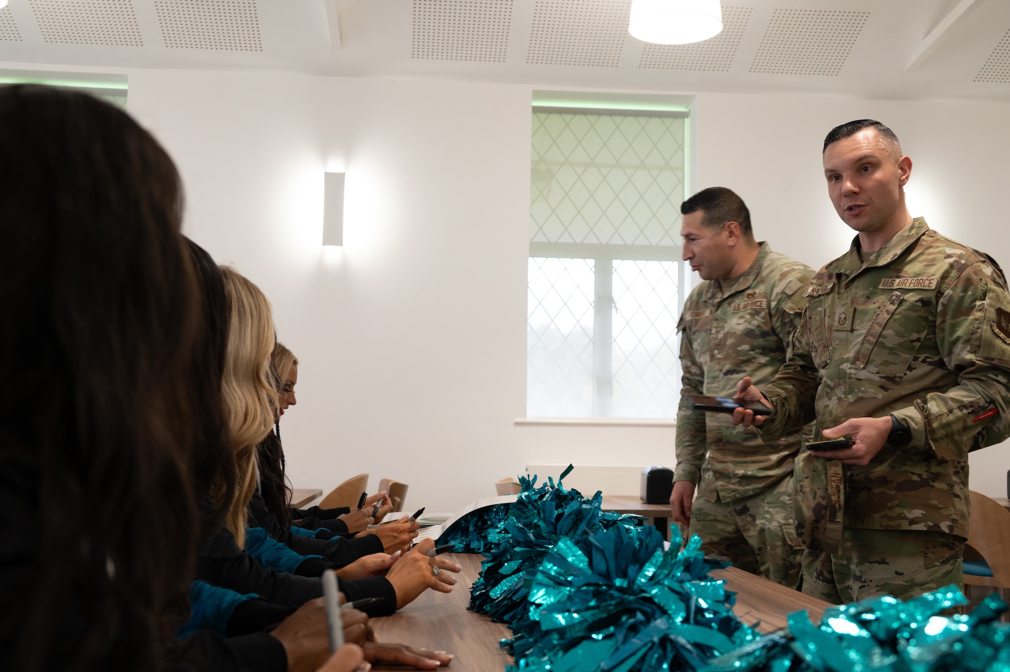Pathfinders talk to the Jacksonville Jaguars Roar Cheerleader Squad during an Armed Forces Entertainment tour meet-and-greet at RAF Fairford