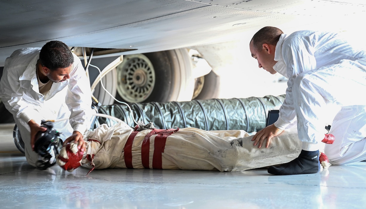 Staff Sgt. Ryan Collier, left, and Senior Airman David Asterino, 445th Maintenance Squadron fuels systems specialists, remove a simulated unresponsive person from the aircraft underfloor maintenance tunnel of a C-17 Globemaster III during a training exercise at Wright-Patterson Air Force Base, Ohio, Sept. 15, 2024.