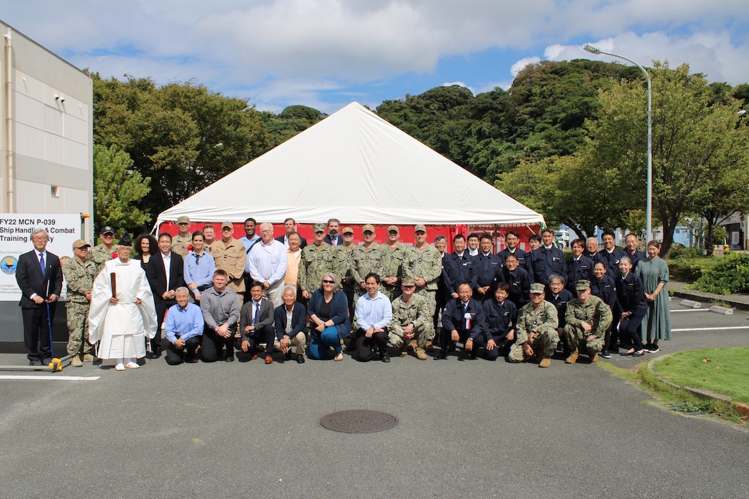 YOKOSUKA, Japan (Oct. 07, 2024) After participating in a groundbreaking ceremony at the site of the P-39 Ship Handling and Combat Training Facility onboard Commander, Fleet Activities Yokosuka, participants pose for a group photo, Oct. 7.  The Ship Handling and Combat Training Facility is planned to be a multi-story building to include high bay space for Integrated Navigation, Seamanship and Ship Handling Trainers, a Radar Navigation Trainer, a Multi-Purpose Reconfigurable Training System, and Surface Combat Systems Training Command’s Combined Integrated Air and Missile Defense Anti-Submarine Warfare Trainer. (U.S. Navy photo)