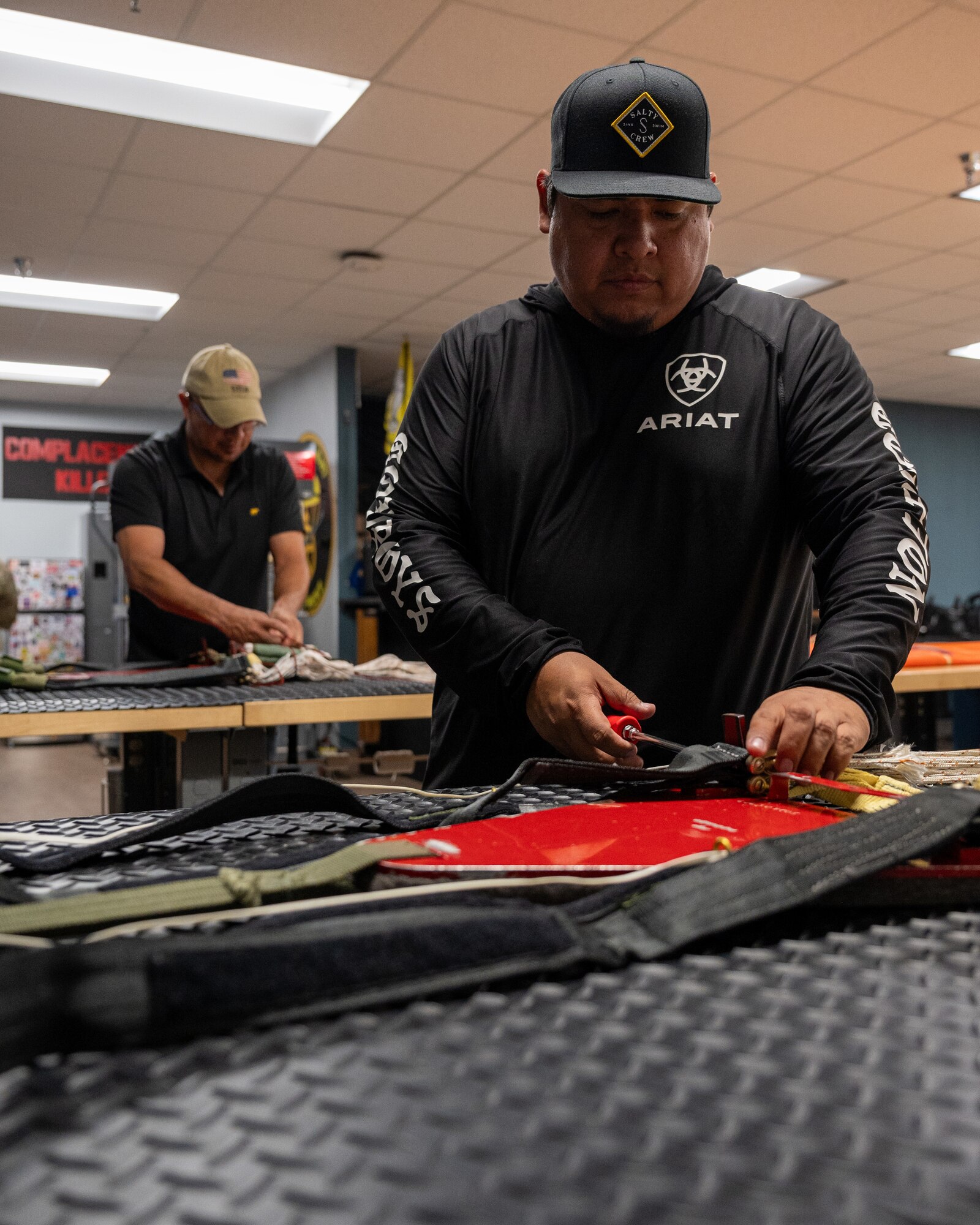 Julio Martinez, 47th Operations Support Squadron (OSS) aircrew flight equipment (AFE) parachute shop section chief, right, repacks parachute rigging while Roger Gloria, 47th OSS AFE parachute rigger, left, disassembles a parachute for inspection, at Laughlin Air Force Base, Texas, Oct. 3, 2024. Parachutes need to be inspected every three to four years, depending on the aircraft in which they are installed, so every parachute needs to be packed so that it will open, even three years after being placed on the ejection seat. (U.S. Air Force photo by Staff Sgt. Nicholas Larsen)
