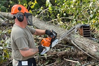 Virginia National Guard Soldiers assigned to the Gate City-based 1032nd Transportation Company, 1030th Transportation Battalion, 329th Regional Support Group, use chainsaws to clear debris in the wake of Hurricane Helene Oct. 3, 2024, in Damascus, Virginia.
