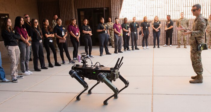 Students from Eldorado High School watch a robot dog demonstration during a tour at Nellis Air Force Base