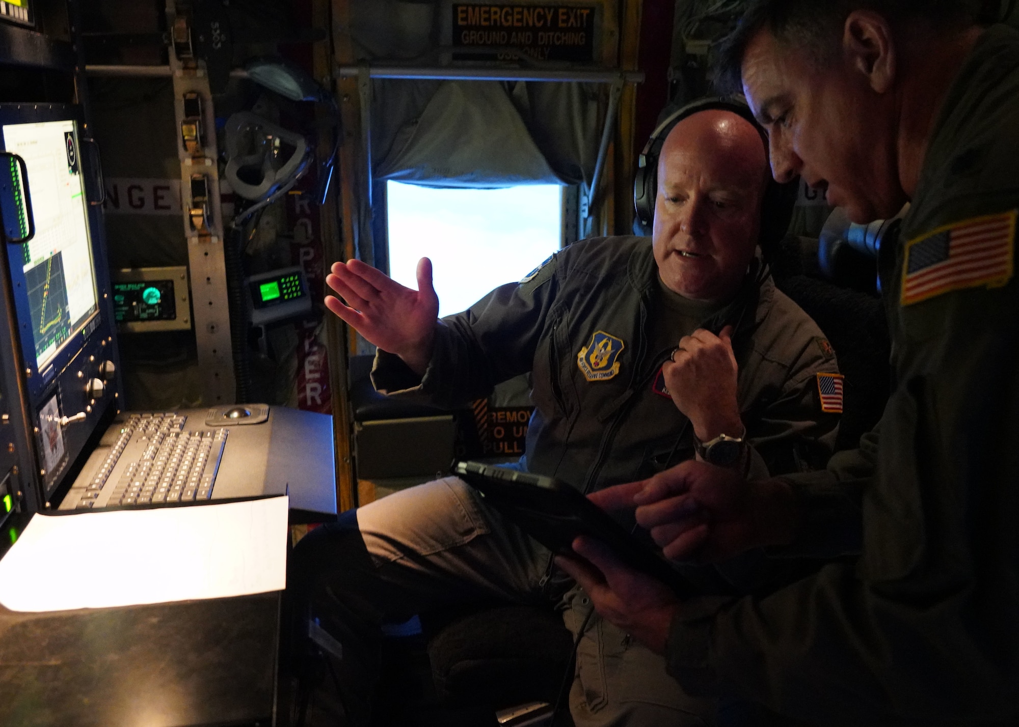 Two aircrew members talking on a WC-130J