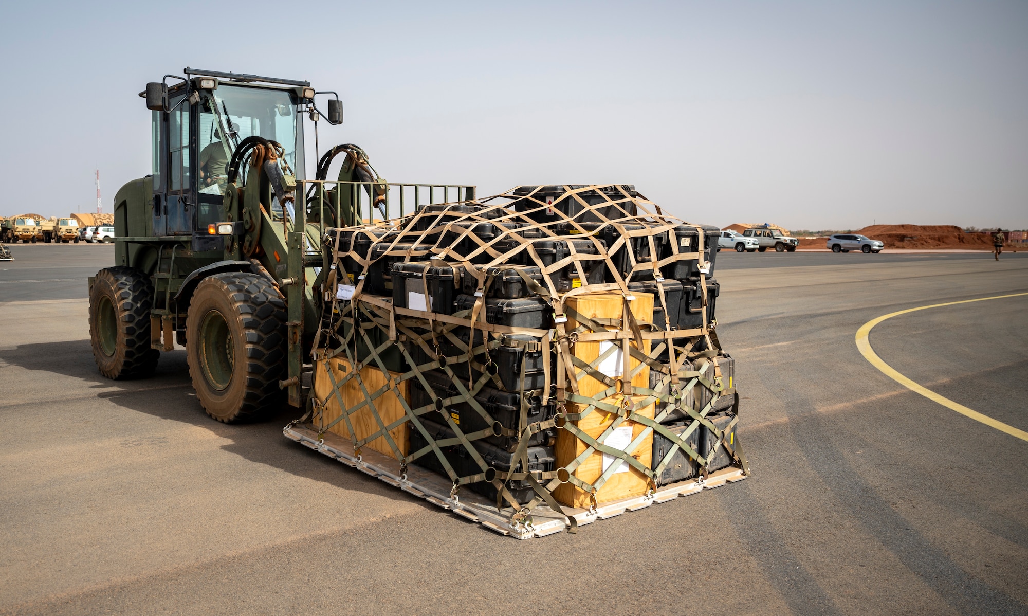 Forklift moves pallet of gear.