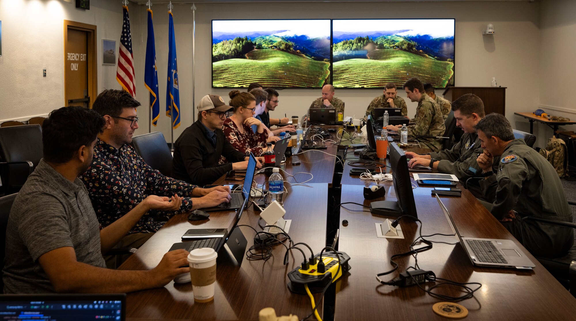 Hackathon participants around room coding