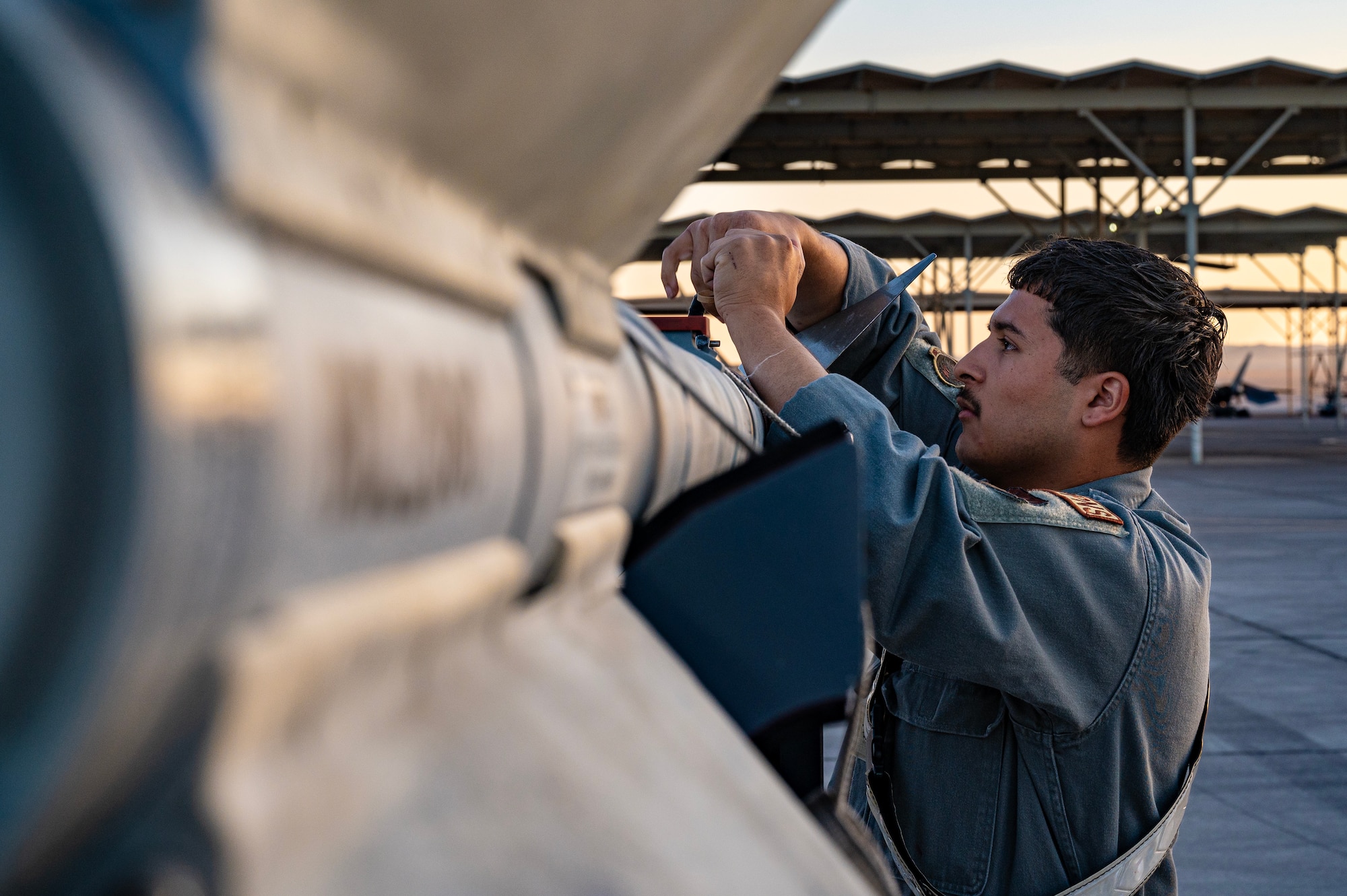 an F-16 Fighting Falcon weapons load crew member competes in the Quarterly Weapons Load Competition
