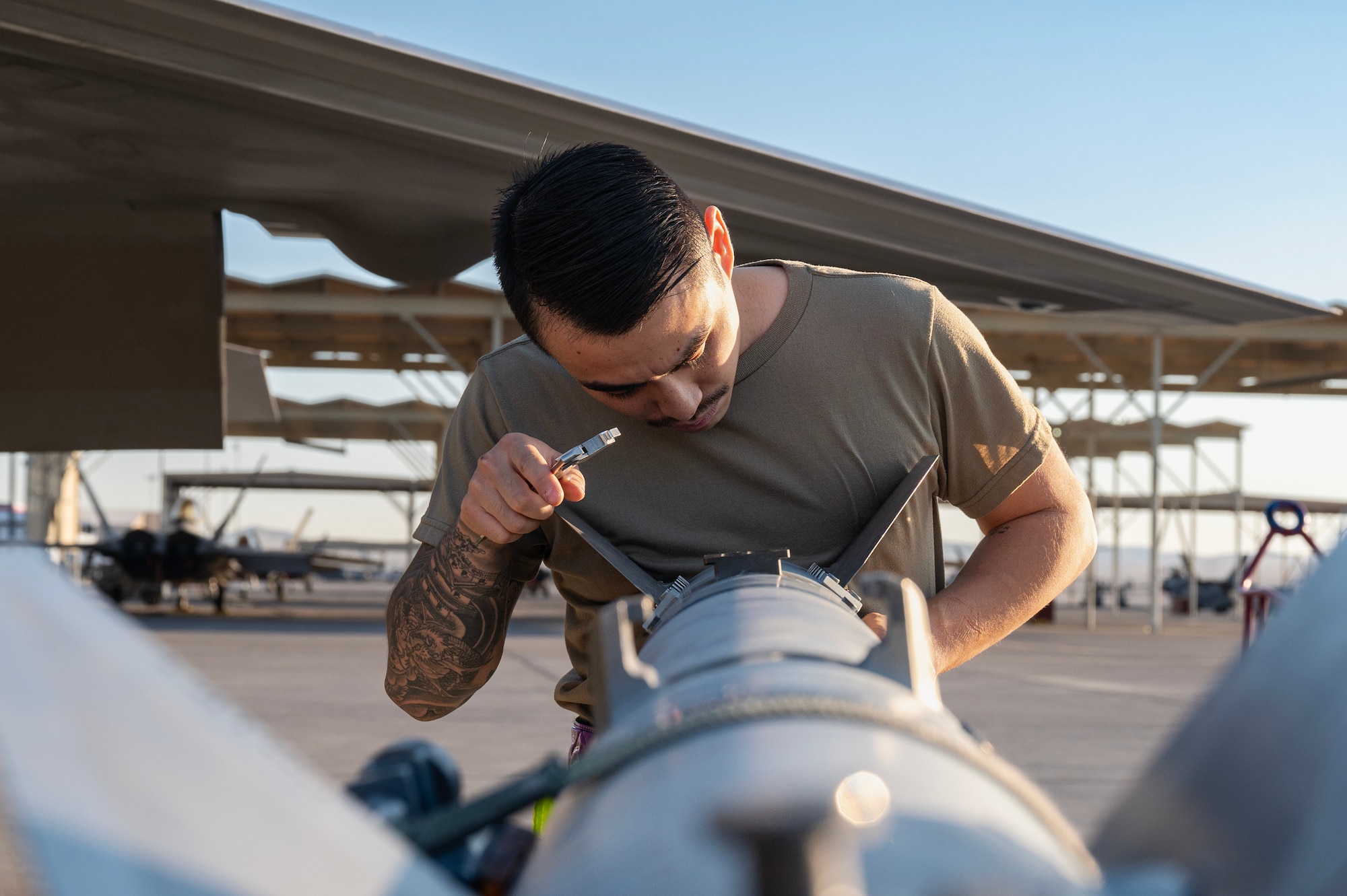 an F-22 Raptor load crew member prepares an inert missile to load onto an F-22 during the Quarterly Weapons Load Competition