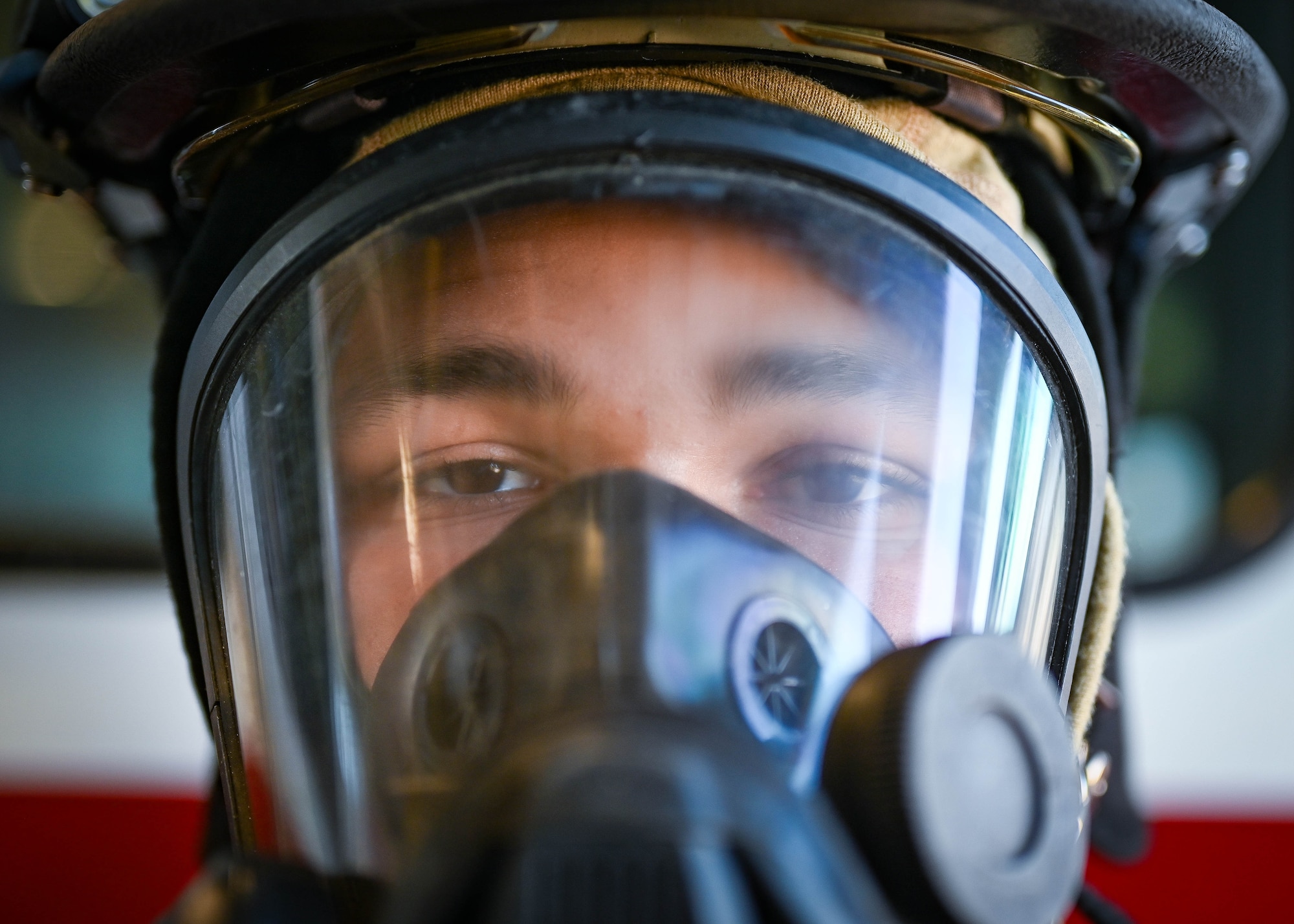 A firefighter dons a safety mask.