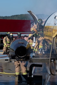 U.S. Airmen assigned to the 130th Fire and Emergency Services enter a simulated plane fire during the major accident response exercise (MARE) on October 05, 2024 at Charleston, W.Va. Team Charlie West trains alongside its strategic partners at West Virginia International Yeager Airport during the MARE, the Federal Aviation Administration requires airports every three years to perform this training to operate commercial aircraft. (U.S Air National Guard photo by Staff Sgt. Takara Williams).