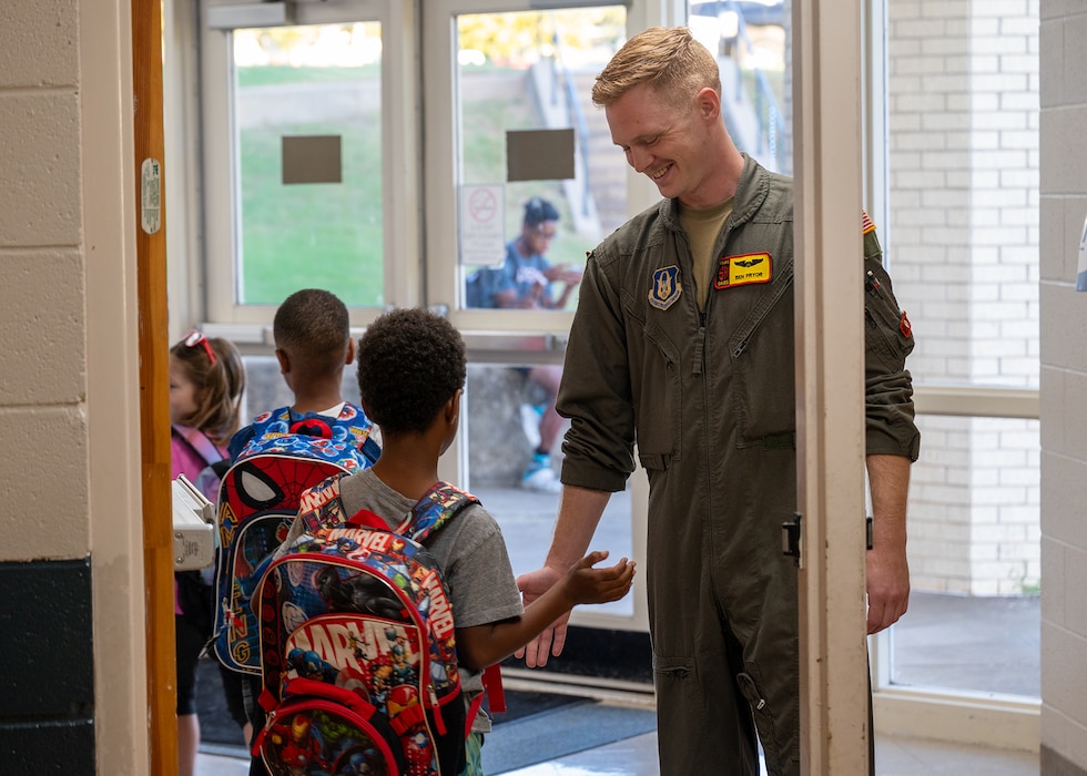 pilot high-fives elementary student