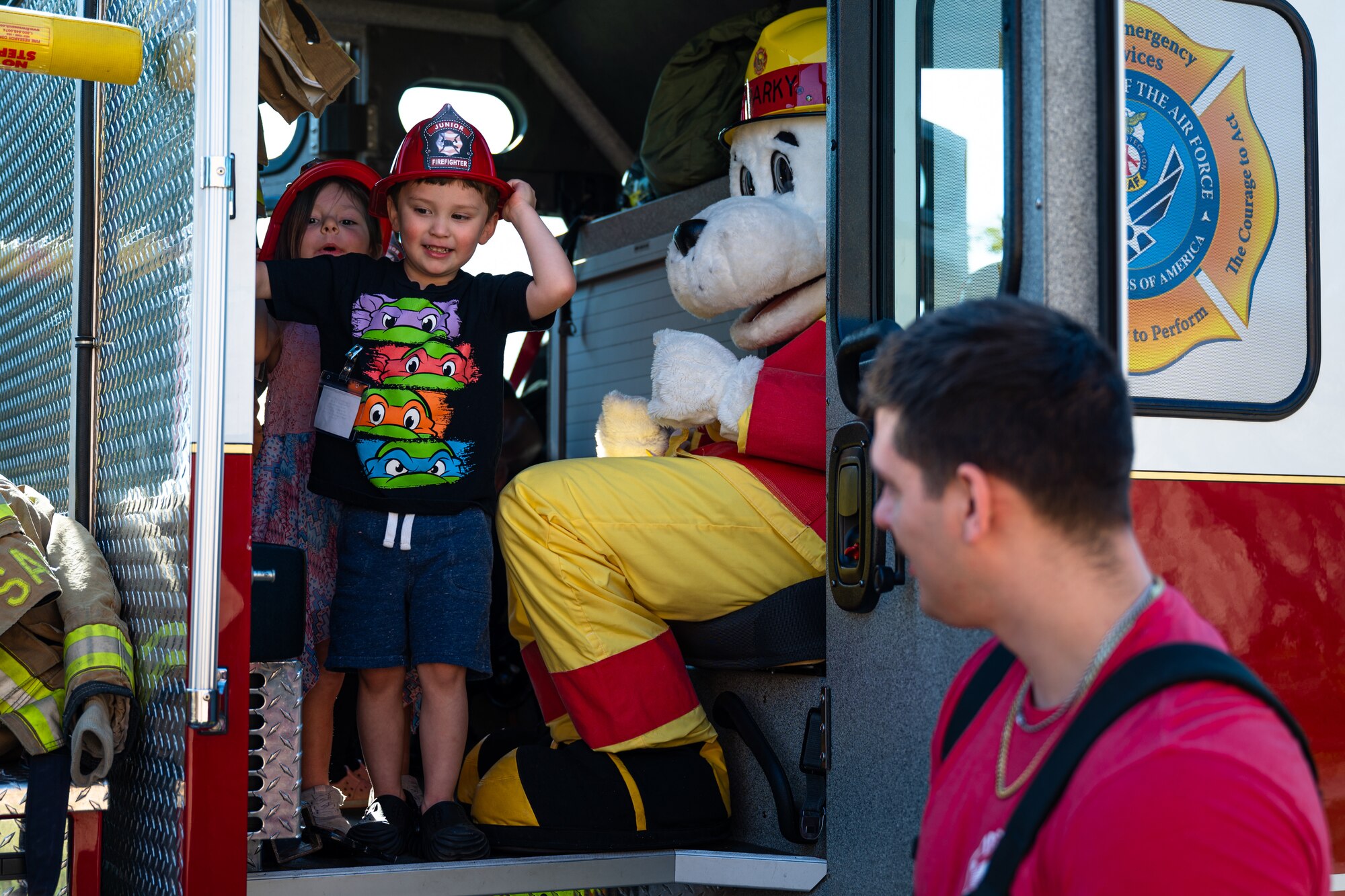 Dyess children tour a fire truck with Sparky the Fire Dog, 7th Civil Engineering Squadron fire department mascot, at Dyess Air Force Base, Texas, Oct. 9, 2024. During Fire Prevention Week, Sparky played a key role in educating children about fire safety. (U.S. Air Force photo by Airman 1st Class Jade M. Caldwell)
