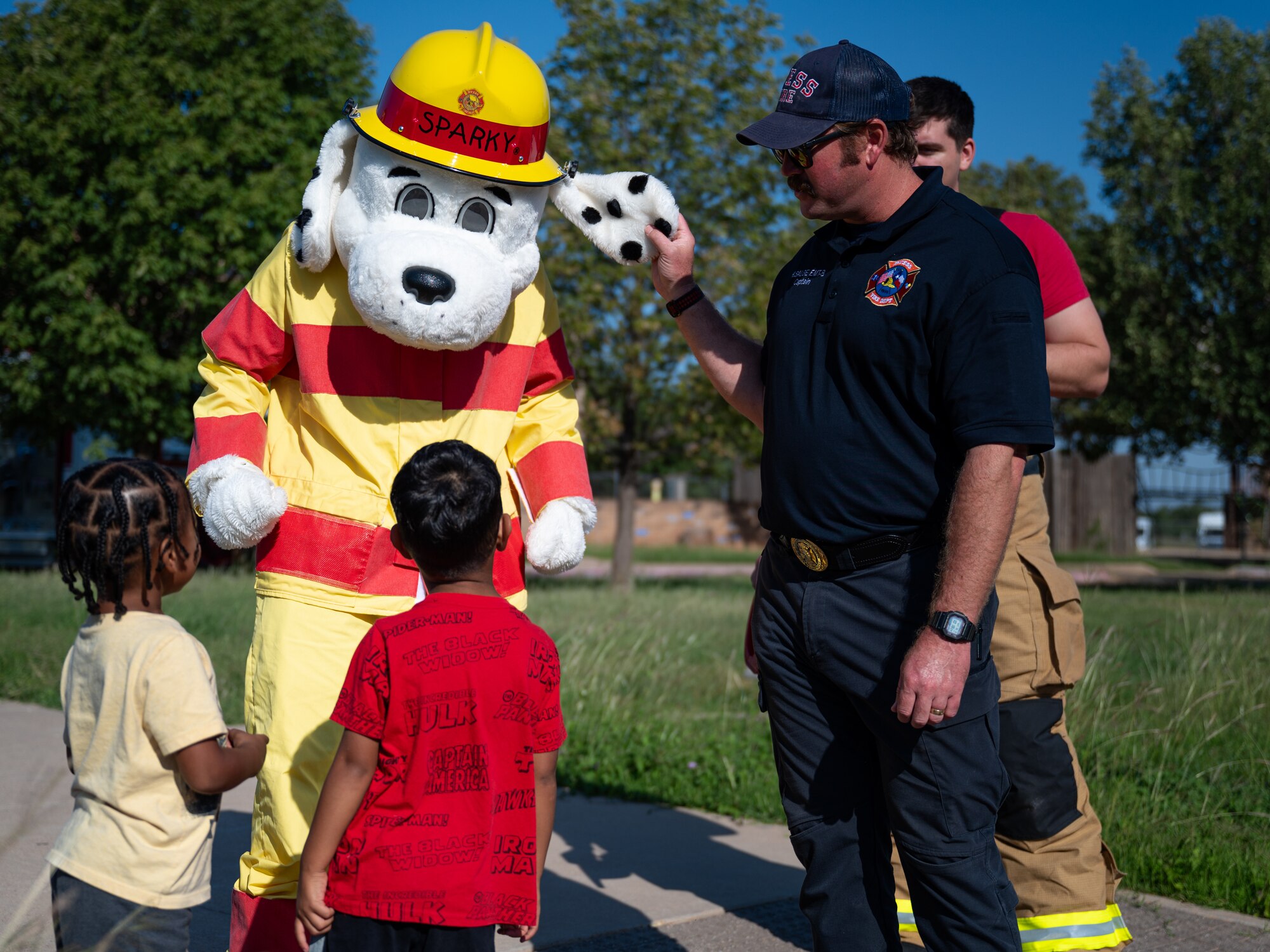 Dyess children learn about fire safety from Sparky the Fire Dog, 7th Civil Engineering Squadron fire department mascot, at Dyess Air Force Base, Texas, Oct. 9, 2024. Dyess AFB held a variety of educational activities on fire safety for children during Fire Prevention Week. (U.S. Air Force photo by Airman 1st Class Jade M. Caldwell)