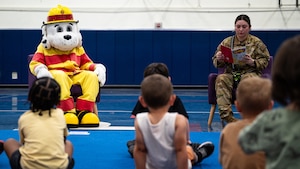 Dyess children learn about Sparky the Fire Dog, 7th Civil Engineering Squadron fire department mascot, at Dyess Air Force Base, Texas, Oct. 9, 2024. Sparky's story gives children the opportunity to learn the importance of fire safety in an engaging environment. (U.S. Air Force photo by Airman 1st Class Jade M. Caldwell)