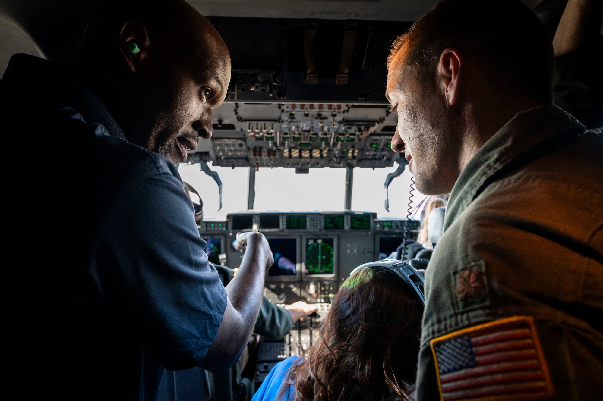 honorary commanders sit in the cockpit of a C-130J