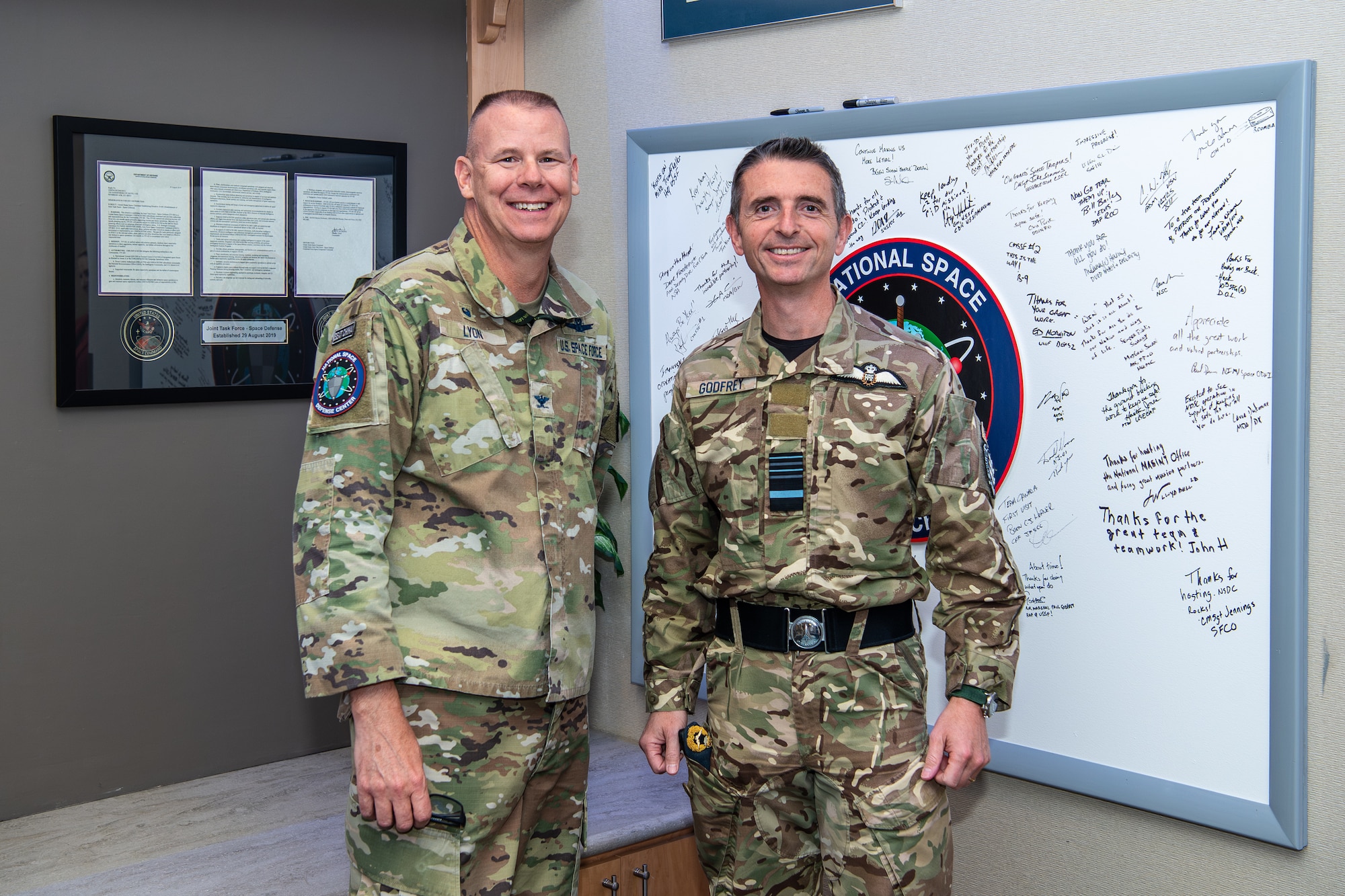 Two military members pose for a photo
