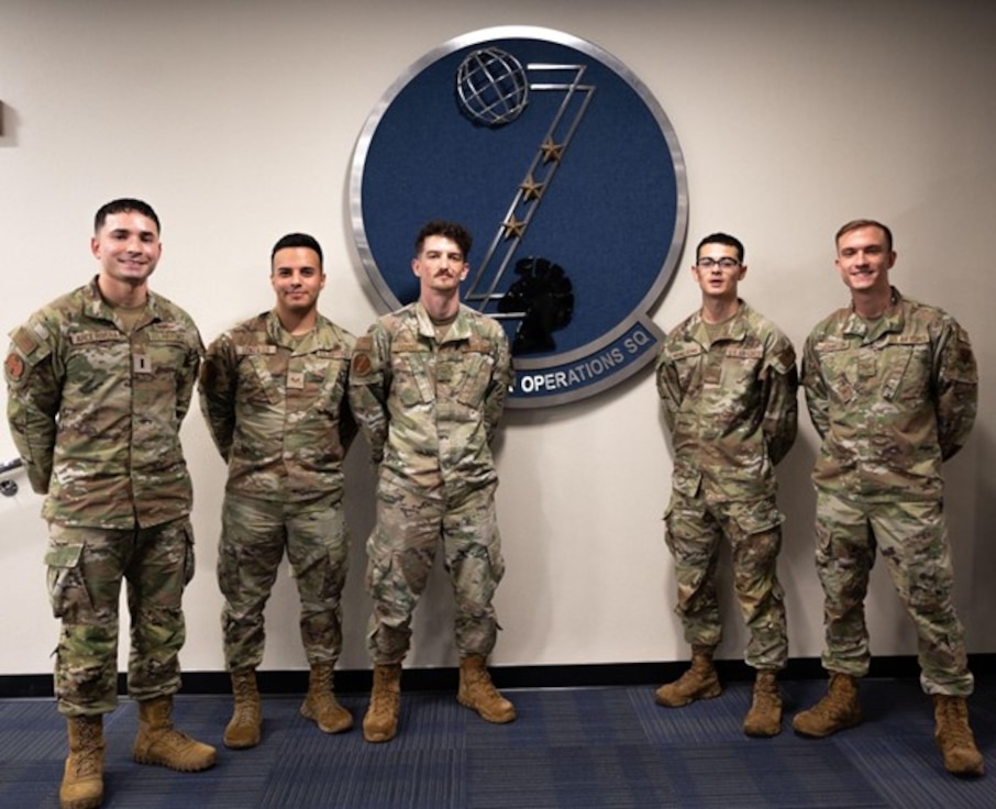 U.S. Air Force Airmen from the 83d Network Operations Squadron pose for a feature photo in front of the squadron’s logo at Joint Base Langley-Eustis, Virginia, Aug. 28, 2024. Cyber Airmen from the 83d NOS strive to overcome any challenge that comes their way by working together.  (U.S. Air Force photo by Amn Donnell Ramsey)