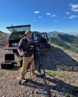 member of the 2d Audiovisual Squadron is seen filming the Warriors Over the Wasatch Open House & Air Show from atop Snowbasin Resort's Strawberry Gondola.