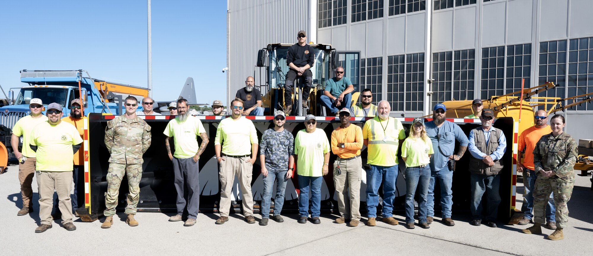A group of individuals pose for a group photo.