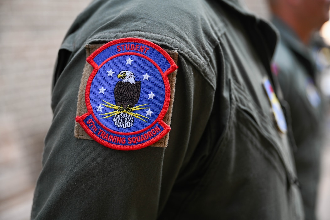 A photo of the 97th Training Training Squadron (TRS) student patch at Altus Air Force Base, Oklahoma, Oct. 7, 2024.  The 97th TRS trained more than 1,900 students in the 2024 fiscal year. (U.S. Air Force photo by Airman 1st Class Jonah Bliss)