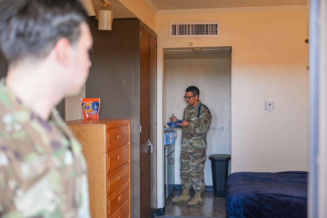 U.S. Air Force Tech. Sgt. Mario Perez, 97th Training Squadron (TRS) military training leader (MTL), conducts a room inspection at the 97th TRS technical training dormitories at Altus Air Force Base, Oklahoma, Oct. 7, 2024. MTLs conduct room inspections to ensure Airmen maintain high standards of cleanliness and organization, reinforcing discipline. (U.S. Air Force photo by Airman 1st Class Jonah Bliss)