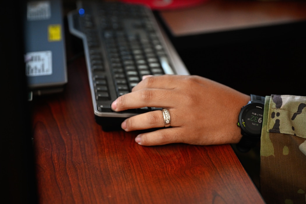 U.S. Air Force Tech. Sgt. Mario Perez, 97th Training Squadron (TRS) Military Training Leader (MTL), types on a keyboard at Altus Air Force Base, Oklahoma, Oct. 7, 2024. Perez has been an MTL for more than three years at the 97th TRS. (U.S. Air Force photo by Airman 1st Class Jonah Bliss)