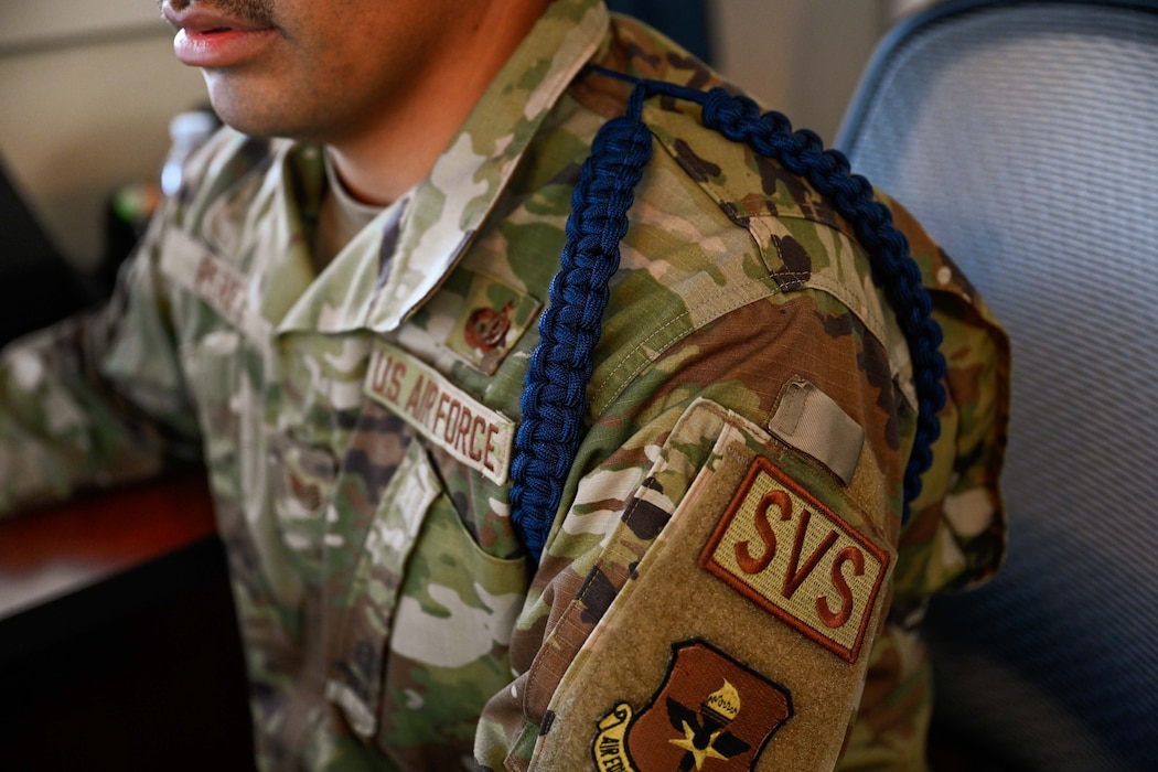 U.S. Air Force Tech. Sgt. Mario Perez, 97th Training Squadron (TRS) military training leader (MTL), displays his MTL aiguillette at Altus Air Force Base, Oklahoma, Oct. 7, 2024. The MTL aiguillette is a symbol of leadership and mentorship, representing the dedication of MTLs to guide and support Airmen. (U.S. Air Force photo by Airman 1st Class Jonah Bliss)