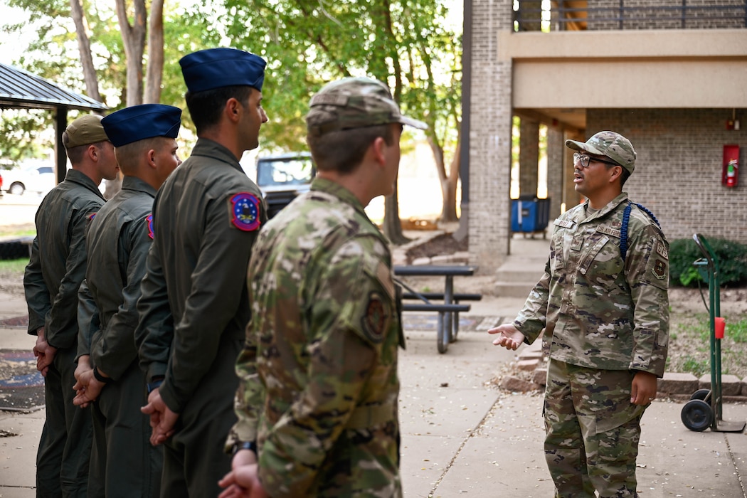 U.S. Air Force Tech. Sgt. Mario Perez, 97th Training Squadron (TRS) military training leader (MTL), speaks with 97th TRS students at Altus Air Force Base, Oklahoma, Oct. 7, 2024. MTLs play a crucial role in shaping the future of our force by mentoring Airmen while learning their new careers. The 97th TRS provides technical training for C-17 Globemaster III aircraft loadmasters, and boom operators for the KC-135 Stratotanker and KC-46 Pegasus. (U.S. Air Force photo by Airman 1st Class Jonah Bliss)