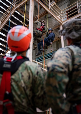 Cpl.  Emili Currey, left, and Jay Gonsalves, a firefighter with the San Francisco Fire Department, practice fast-rope techniques during San Francisco Fleet Week.