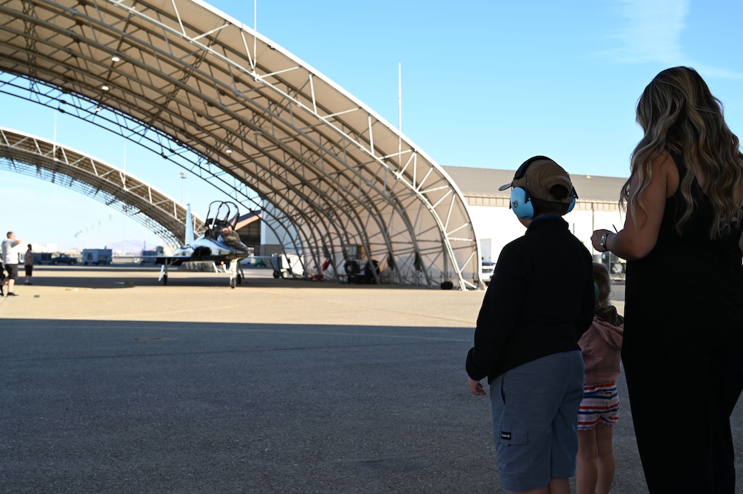 U.S. Air Force Reserve Tech. Sgt. Joshua Crawley’s family wait for Crawley’s plane to taxi at Beale Air Force Base, California, Oct. 9, 2024.