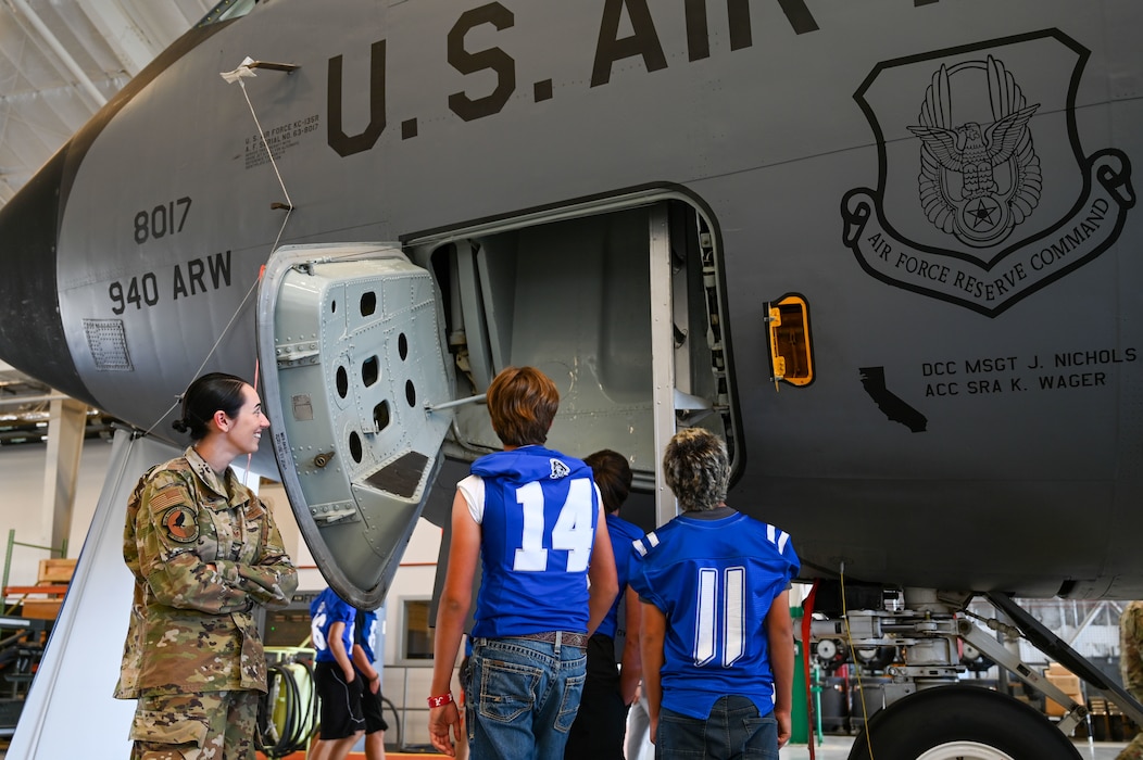 Students from Wheatland Union High School look into the door of a KC-135R Stratotanker air-to-air refueling aircraft of the 940th Air Refueling Wing during a tour at Beale Air Force Base, California, Oct. 9, 2024.