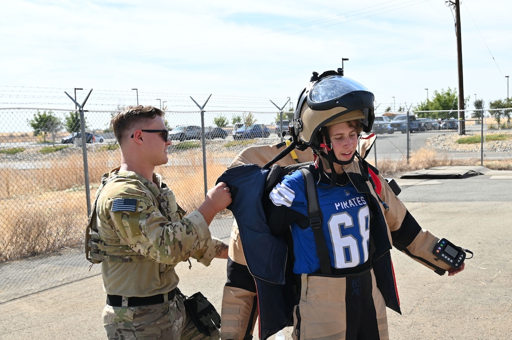 Kane Burton, a Wheatland Union High School student, takes off an Explosives Ordnance Disposal (EOD) suit after jogging around with EOD technicians at Beale Air Force Base, California, Oct. 9, 2024