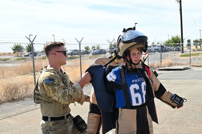 Kane Burton, a Wheatland Union High School student, takes off an Explosives Ordnance Disposal (EOD) suit after jogging around with EOD technicians at Beale Air Force Base, California, Oct. 9, 2024