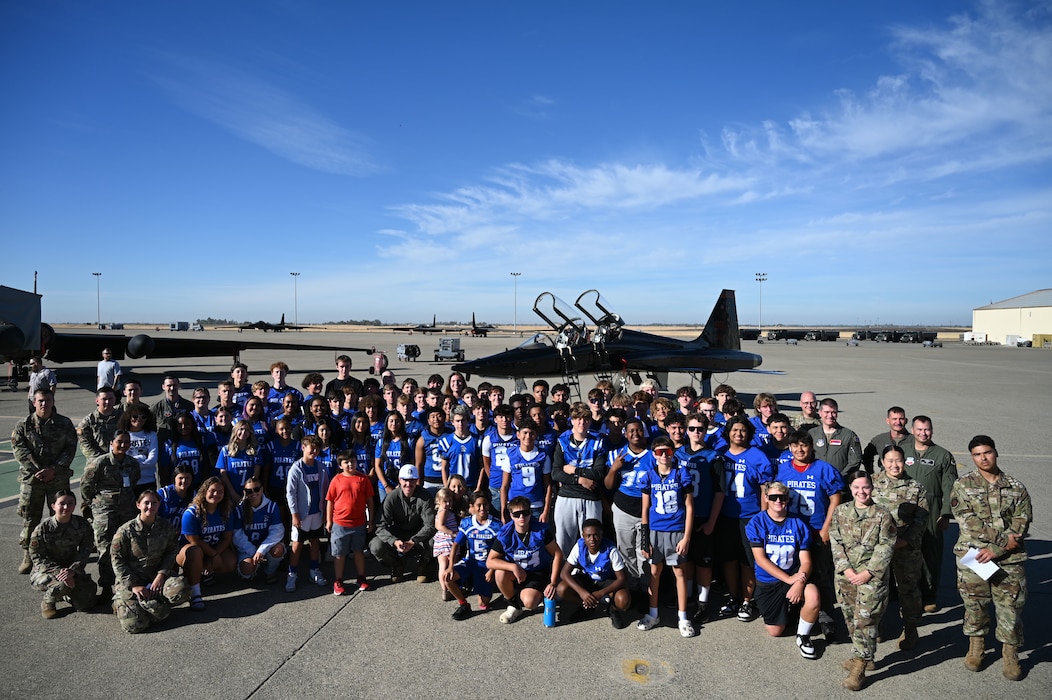 Wheatland Union High School men and women’s football teams poset with U.S. Air Force Airmen in front of a T-38 Talon at Beale Air Force Base, California, Oct. 9, 2024