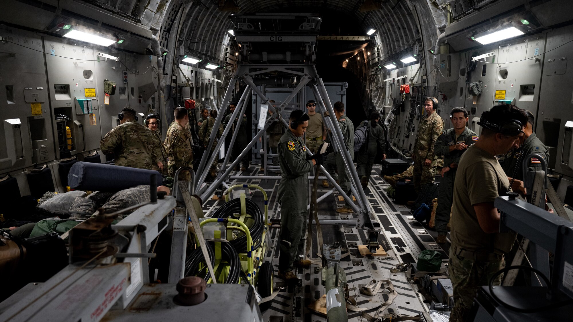 U.S. Air Force Airmen start unloading cargo from a C-17 Globemaster III aircraft.