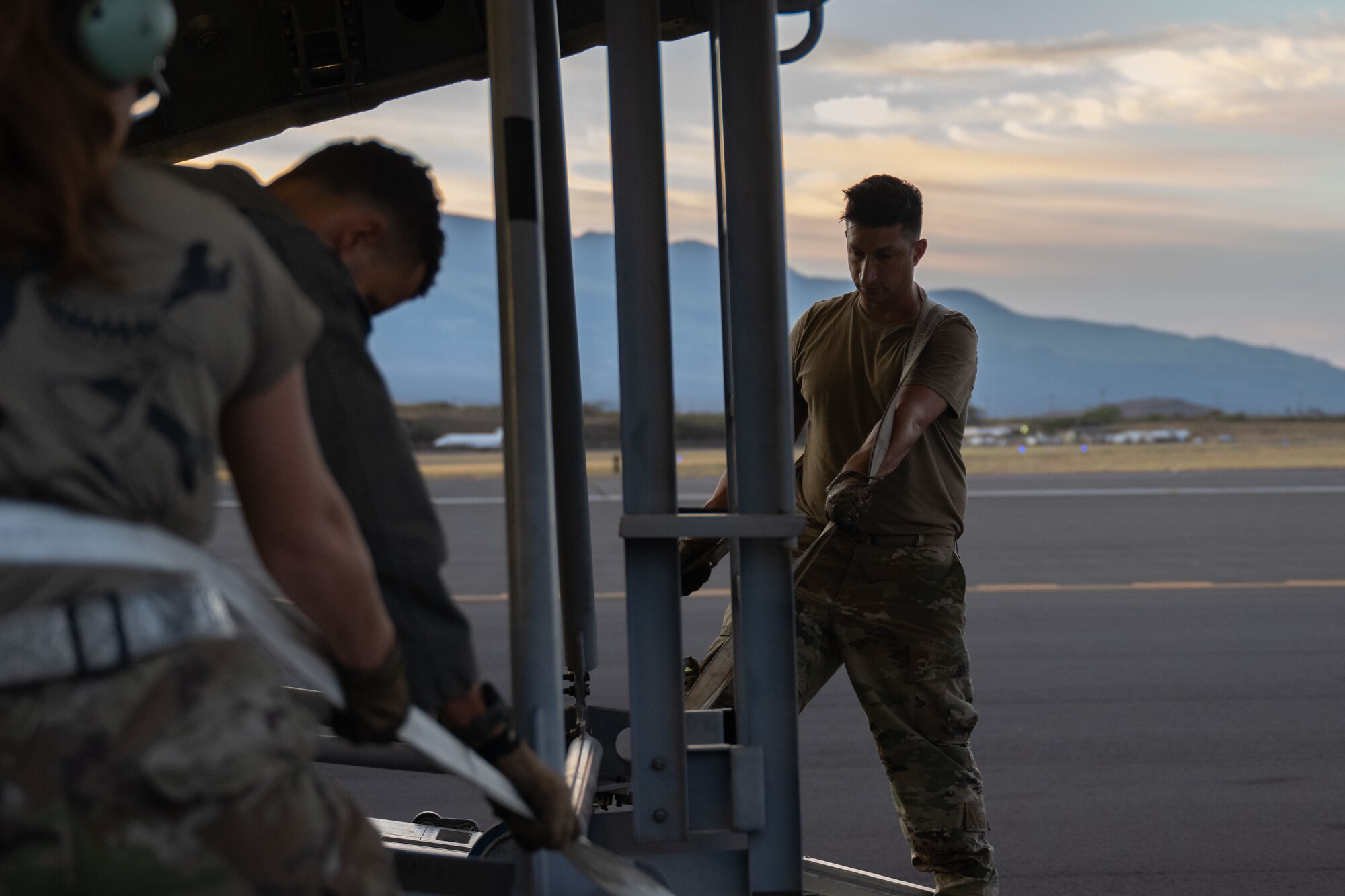 U.S. Air Force Airmen unload an aircraft ladder from a C-17 Globemaster III aircraft.