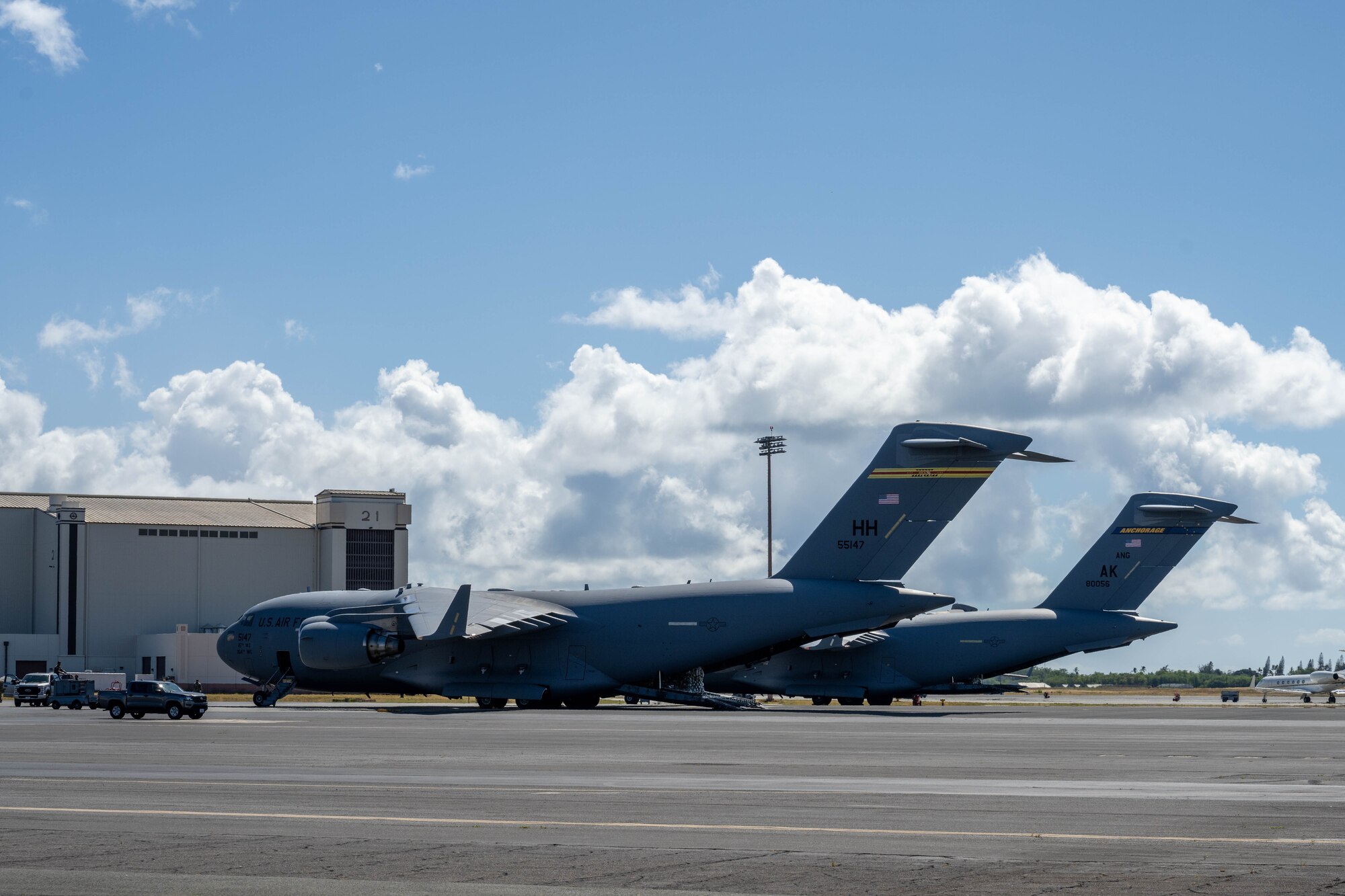 Two U.S. Air Force C-17 Globemaster IIIs are parked on a flightline.