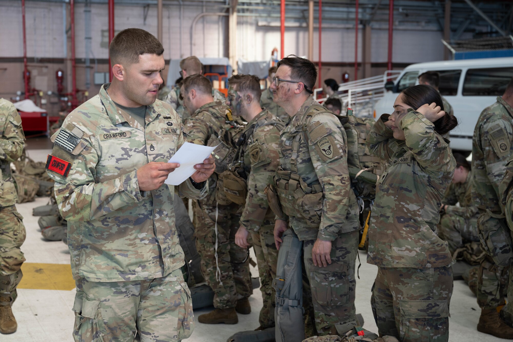 A U.S. Army Soldier walks around with a paper.