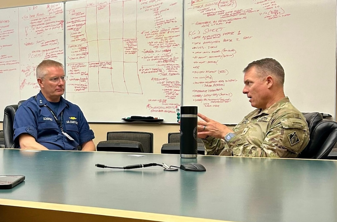 U.S. Coast Guard District Seven commander, Rear Adm. Douglas Schofield, meets with U.S. Army Corps of Engineers South Atlantic Division commander, Brig. Gen. Daniel Hibner, to discuss Hurricane Milton response efforts at the Florida Emergency Operations Center in Tallahassee, Oct. 10, 2024. Partnership efforts continue in support the State of Florida regarding the assessment and reconstitution of operations in commercial seaports following hurricane Milton. (U.S. Army Corps of Engineers courtesy photo)