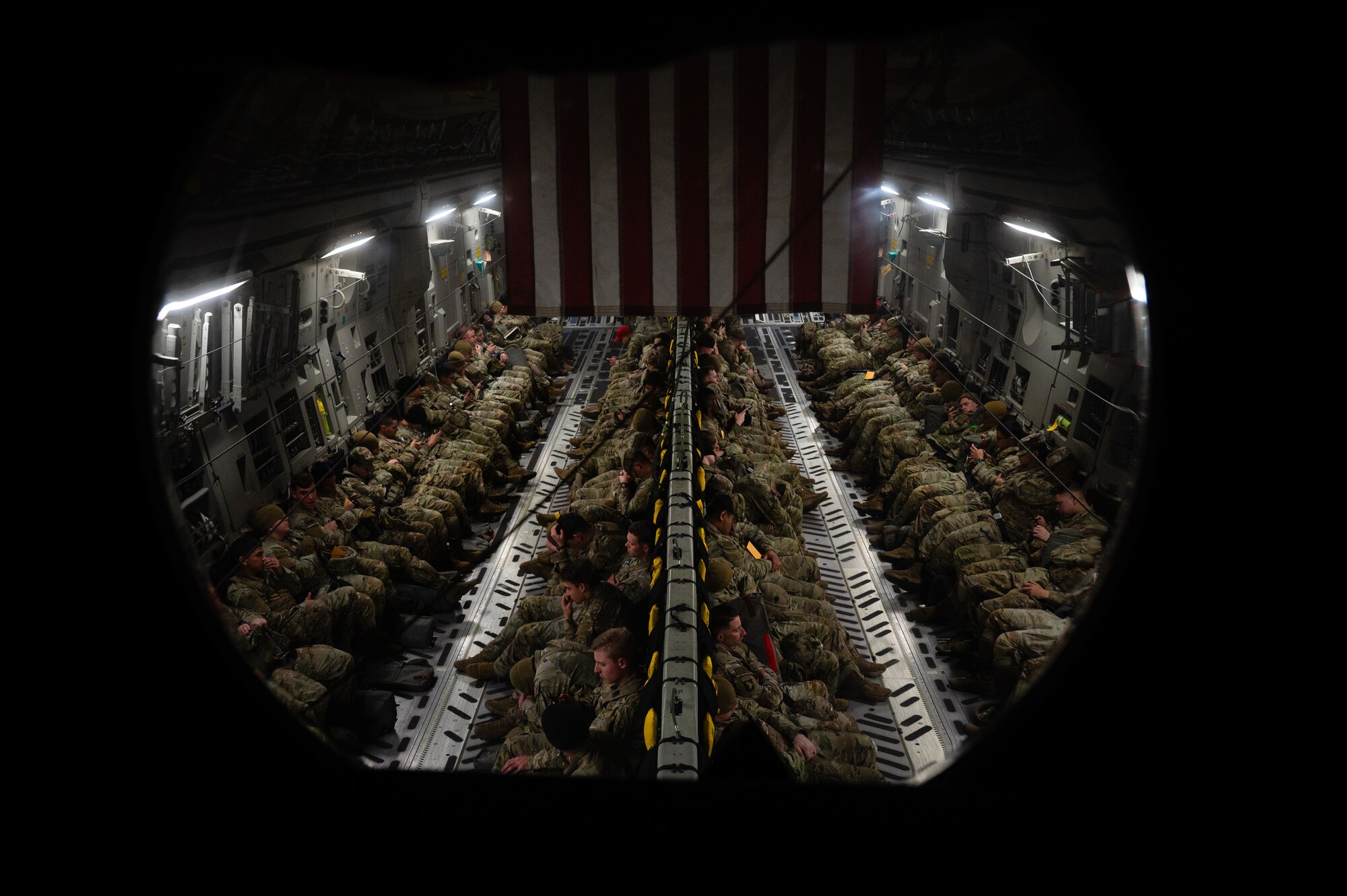 U.S. Army Soldiers ride inside a C-17 Globemaster III aircraft.