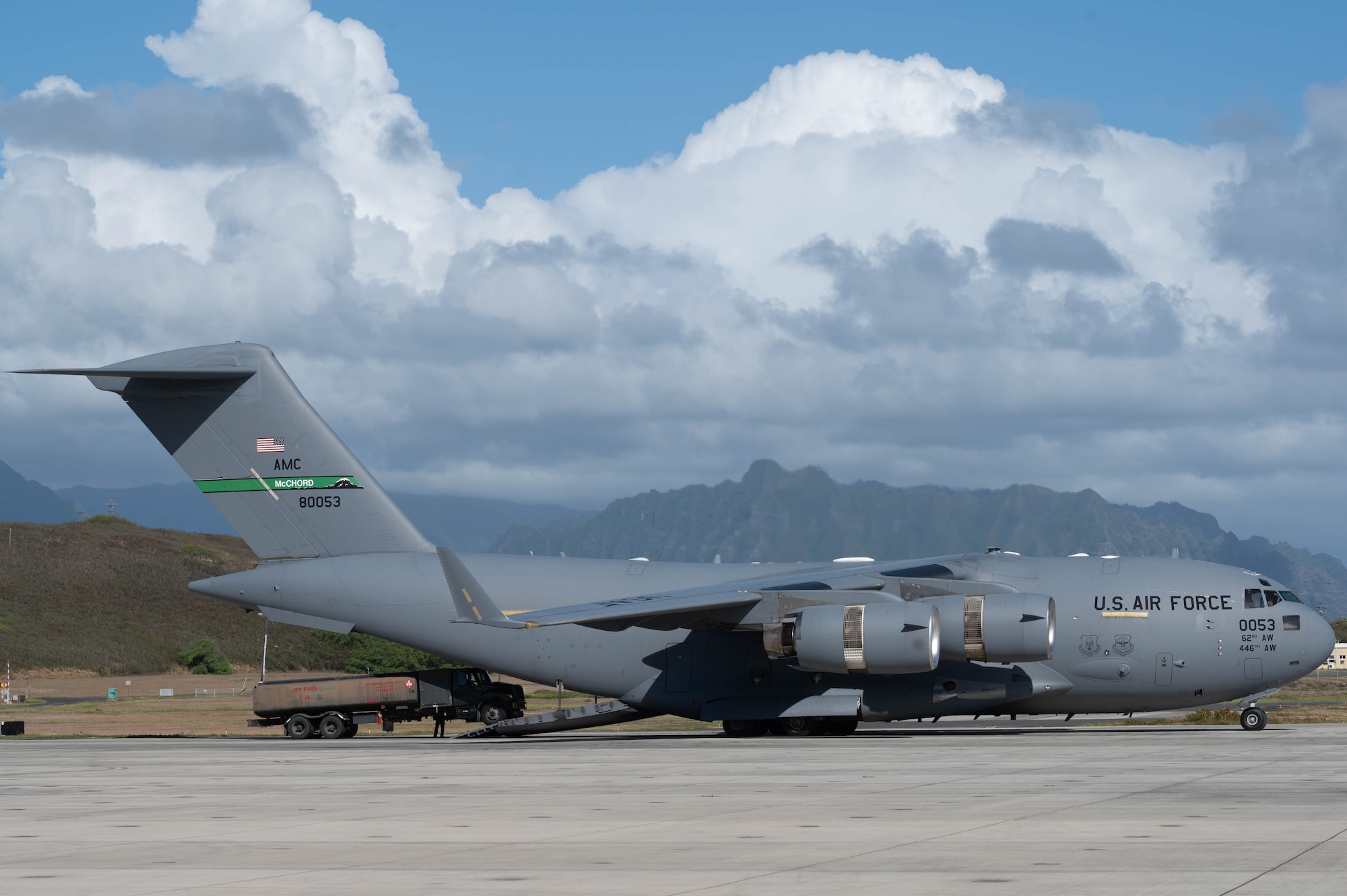 An aircraft refueling truck is being loaded into a C-17 Globemaster III aircraft.