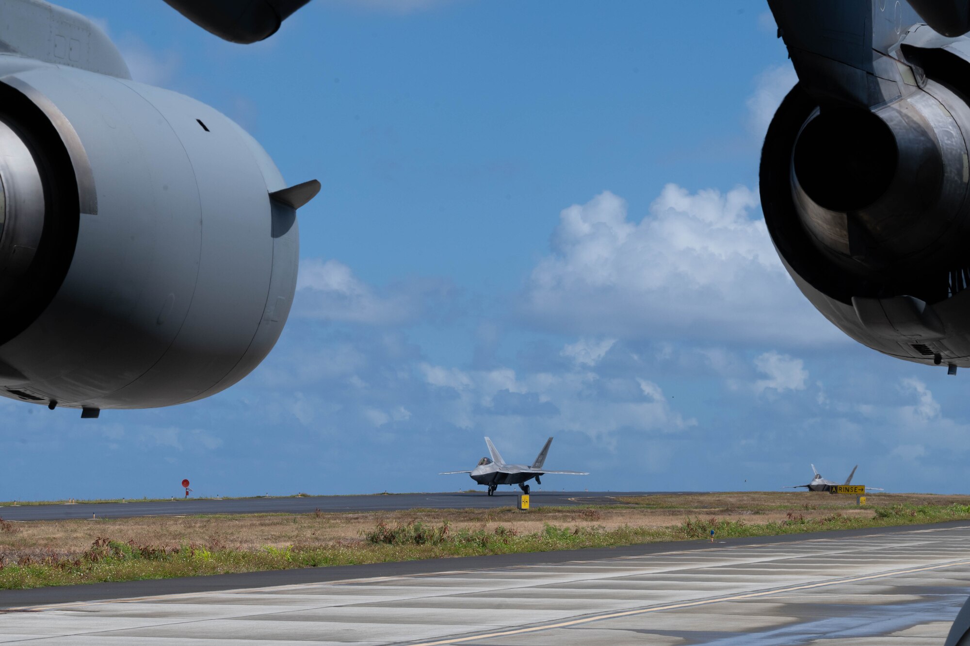 An F-22 Raptor aircraft sits on a flightline.